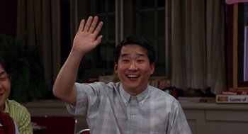 Movie still from “Harold & Kumar Go to White Castle” (2004), directed by Danny Leiner – A man waving at the camera with his hand in the air; Medium shot, Low angle
