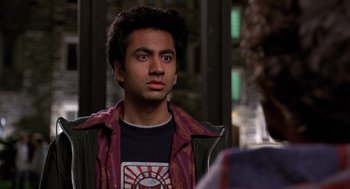 Movie still from “Harold & Kumar Go to White Castle” (2004), directed by Danny Leiner – A man in a black t - shirt is looking to his left; Close Up shot, Over the shoulder angle