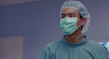 Movie still from “Harold & Kumar Go to White Castle” (2004), directed by Danny Leiner – A man wearing a surgical mask in a hospital room; Close Up shot, Low angle