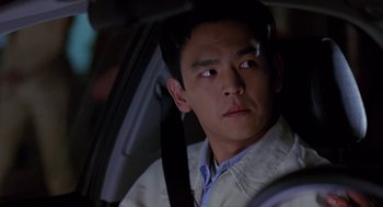 Movie still from “Harold & Kumar Go to White Castle” (2004), directed by Danny Leiner – A man sitting in the driver's seat of a car at night; Close Up shot, Over the shoulder angle