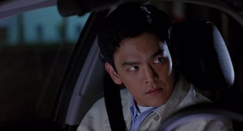 Movie still from “Harold & Kumar Go to White Castle” (2004), directed by Danny Leiner – A man sitting in the back seat of a car; Close Up shot, Over the shoulder angle