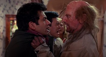 Movie still from “Harold & Kumar Go to White Castle” (2004), directed by Danny Leiner – Two men are fighting with a zombie in a crowd; Close Up shot, Over the shoulder angle