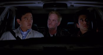 Movie still from “Harold & Kumar Go to White Castle” (2004), directed by Danny Leiner – A group of people sitting in a car at night; Medium shot, Over the shoulder angle