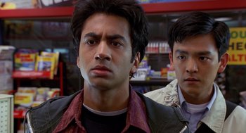 Movie still from “Harold & Kumar Go to White Castle” (2004), directed by Danny Leiner – Two men standing next to each other in front of a store; Close Up shot, Over the shoulder angle