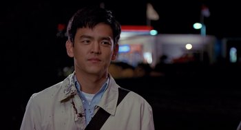 Movie still from “Harold & Kumar Go to White Castle” (2004), directed by Danny Leiner – A man with a knife in his mouth; Close Up shot, Over the shoulder angle