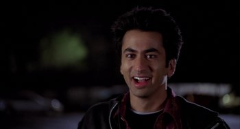 Movie still from “Harold & Kumar Go to White Castle” (2004), directed by Danny Leiner – A person with a smile on their face; Close Up shot, High angle
