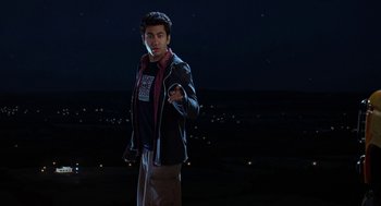 Movie still from “Harold & Kumar Go to White Castle” (2004), directed by Danny Leiner – A man standing in a field at night; Medium shot, Low angle