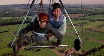 Movie still from “Harold & Kumar Go to White Castle” (2004), directed by Danny Leiner – Two men are hanging from a hang - glider; Medium shot, Low angle
