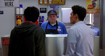 Movie still from “Harold & Kumar Go to White Castle” (2004), directed by Danny Leiner – A man standing in front of two other men; Medium shot, Over the shoulder angle