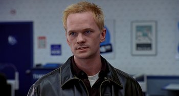 Movie still from “Harold & Kumar Go to White Castle” (2004), directed by Danny Leiner – A person wearing a leather jacket; Close Up shot, Over the shoulder angle