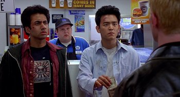 Movie still from “Harold & Kumar Go to White Castle” (2004), directed by Danny Leiner – A group of men standing in front of each other; Medium shot, Over the shoulder angle