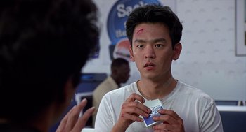 Movie still from “Harold & Kumar Go to White Castle” (2004), directed by Danny Leiner – A young man holding a pack of tissues in front of a mirror; Close Up shot, Over the shoulder angle