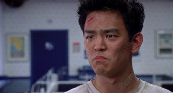 Movie still from “Harold & Kumar Go to White Castle” (2004), directed by Danny Leiner – A man with a bandage on his head and face; Close Up shot, Low angle