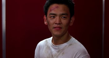 Movie still from “Harold & Kumar Go to White Castle” (2004), directed by Danny Leiner – A young man with a red cross on his forehead; Close Up shot, High angle