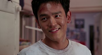 Movie still from “Harold & Kumar Go to White Castle” (2004), directed by Danny Leiner – A young man with a scar on his face; Close Up shot, Over the shoulder angle